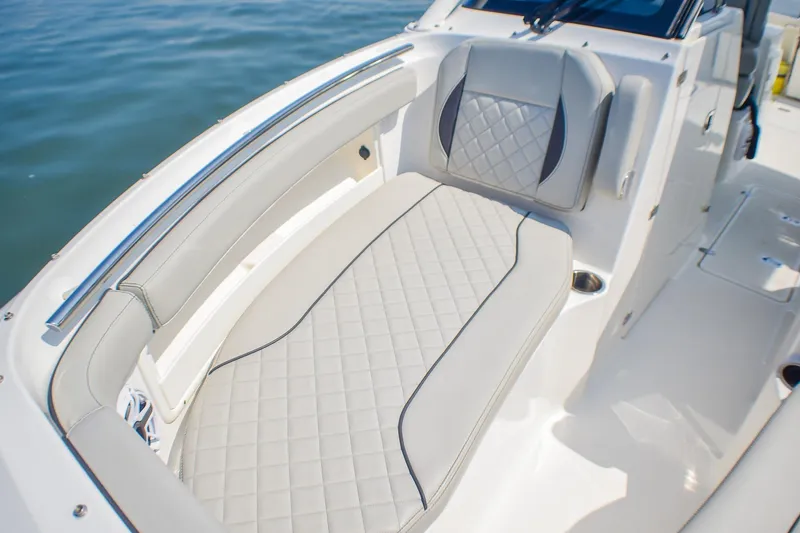 Slide: The Image of 2023 Pursuit DC 266 Dual Console boat with luxurious seating and elegant design. - 11