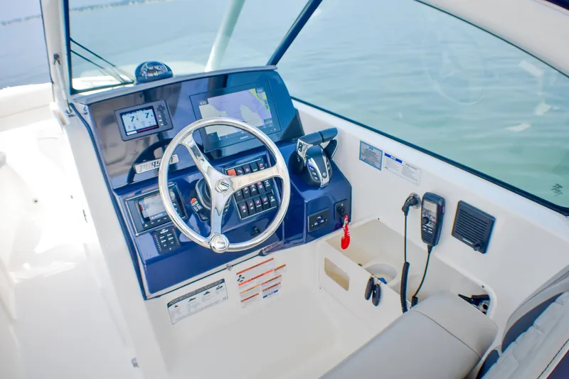Slide: The Image of 2023 Pursuit DC 266 Dual Console boat helm with modern controls and navigation system. - 13