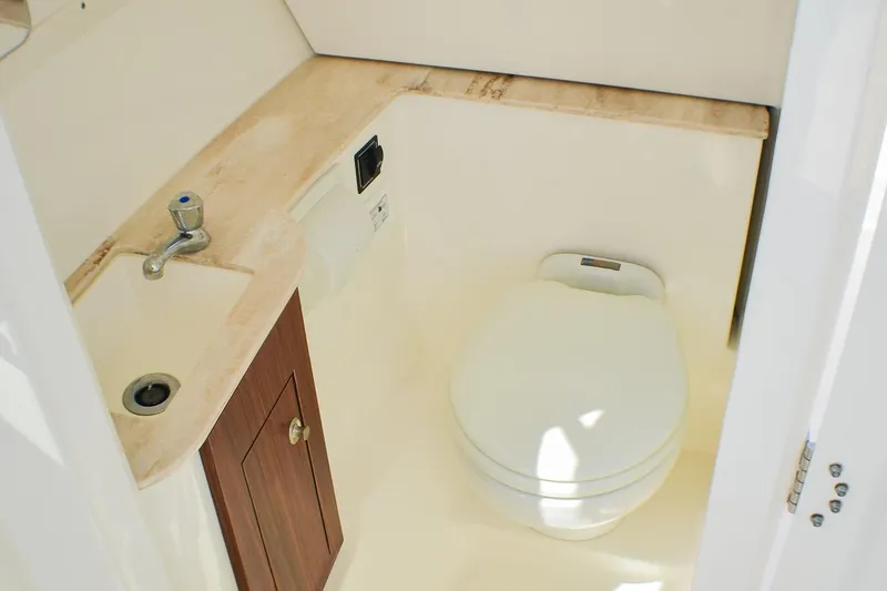 Slide: The Image of 2023 Pursuit DC 266 Dual Console boat bathroom with sink and toilet. - 15