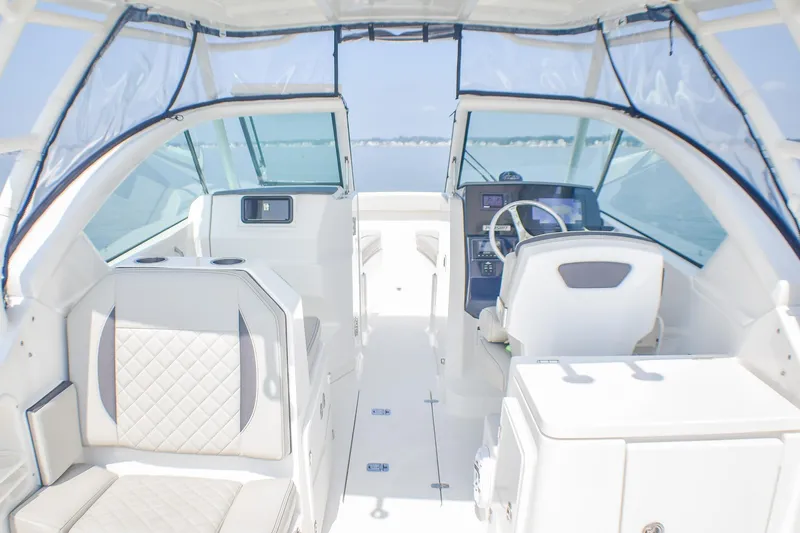 Slide: The Image of 2023 Pursuit DC 266 Dual Console boat interior with modern seating and steering console. - 19