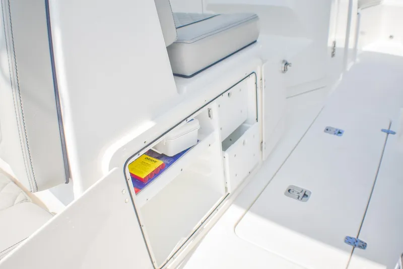 Slide: The Image of 2023 Pursuit DC 266 Dual Console boat interior storage compartment. - 21