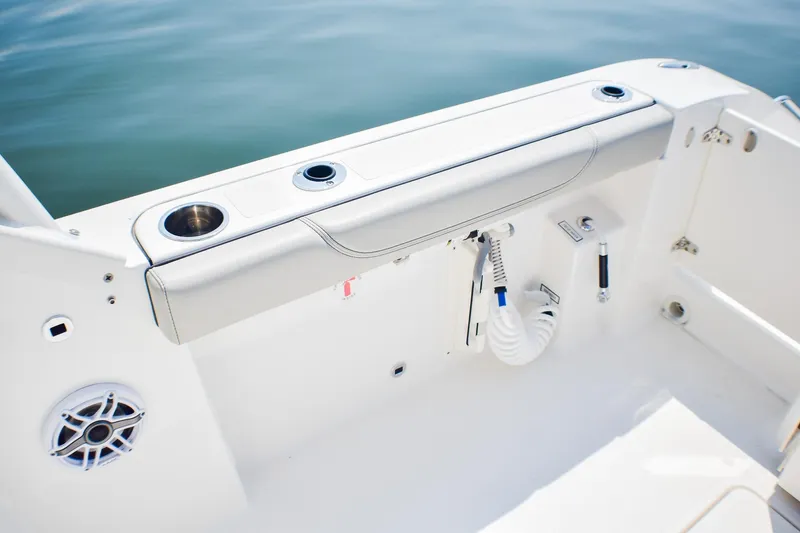 Slide: The Image of 2023 Pursuit DC 266 Dual Console boat interior with cup holders and speaker. - 26