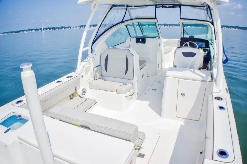 Slide: The Image of 2023 Pursuit DC 266 Dual Console boat interior on calm water. - 28