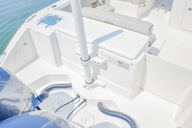 Slide: The Image of 2023 Pursuit DC 266 Dual Console boat interior with American Made label, showcasing seating and equipment. - 29