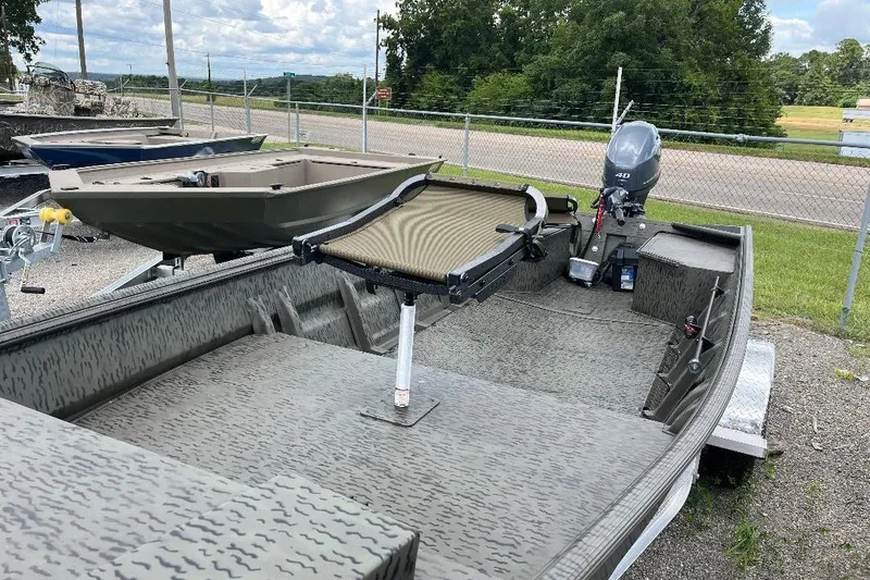 Slide: The Image of 2026 War Eagle 648LDV boat with motor, parked outdoors on a trailer. - 11