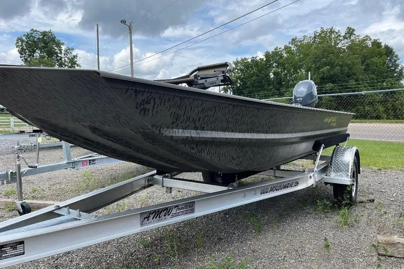 Slide: The Image of 2026 War Eagle 648LDV boat on trailer, parked outdoors, with cloudy sky background. - 3