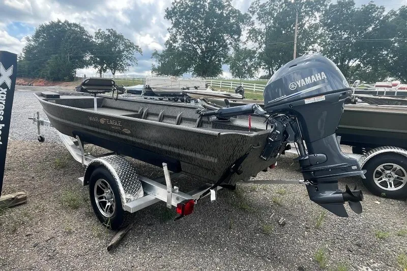 Slide: The Image of 2026 War Eagle 648LDV boat with Yamaha motor on trailer, parked outdoors. - 4