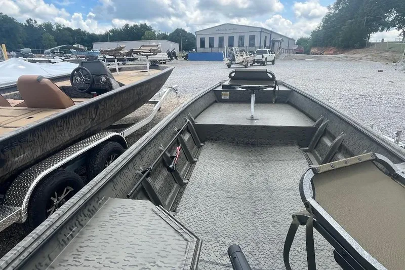 Slide: The Image of 2026 War Eagle 648LDV boat in a dealership lot, showcasing spacious interior and durable design. - 5