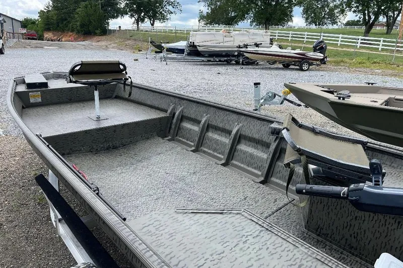 Slide: The Image of 2026 War Eagle 648LDV boat on gravel lot, featuring spacious interior and seating. - 8