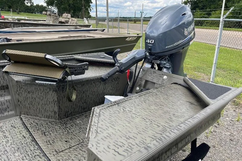Slide: The Image of War Eagle 648LDV 2026 boat with Yamaha 40HP outboard motor, parked outdoors. - 9