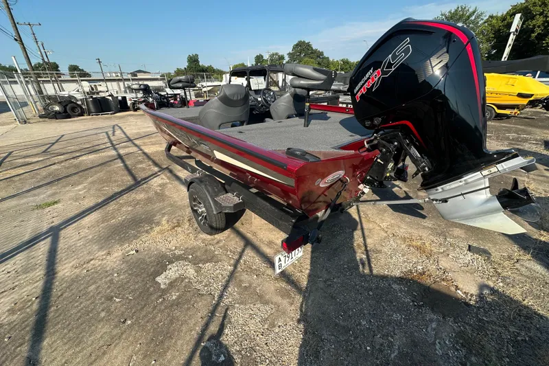 Slide: The Image of 2022 Lowe Stinger 188 boat with powerful outboard motor, parked outdoors. - 4