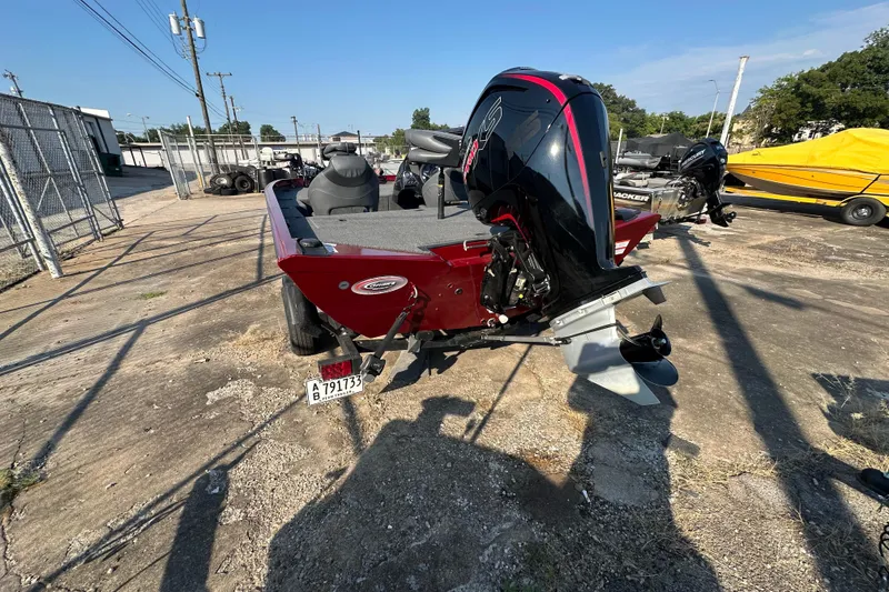 Slide: The Image of 2022 Lowe Stinger 188 boat with powerful outboard motor, parked outdoors. - 5