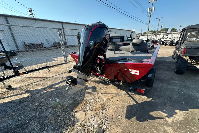 Slide: The Image of 2022 Lowe Stinger 188 boat with outboard motor in a storage yard. - 6