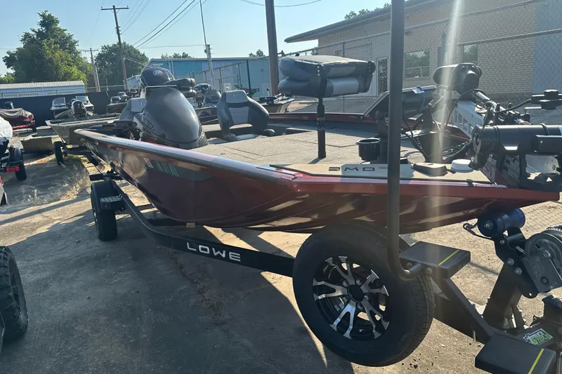 Slide: The Image of 2022 Lowe Stinger 188 boat on trailer, parked outdoors in a lot. - 7