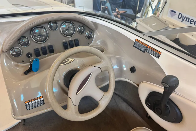 Slide: The Image of 2002 Maxum 1800 SR boat dashboard with steering wheel and control panel. - 10