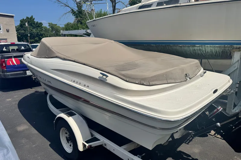 Slide: The Image of 2002 Maxum 1800 SR boat on trailer with cover in parking lot. - 14