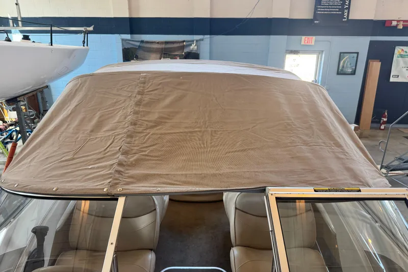 Slide: The Image of 2002 Maxum 1800 SR boat with beige canvas cover in indoor storage. - 17