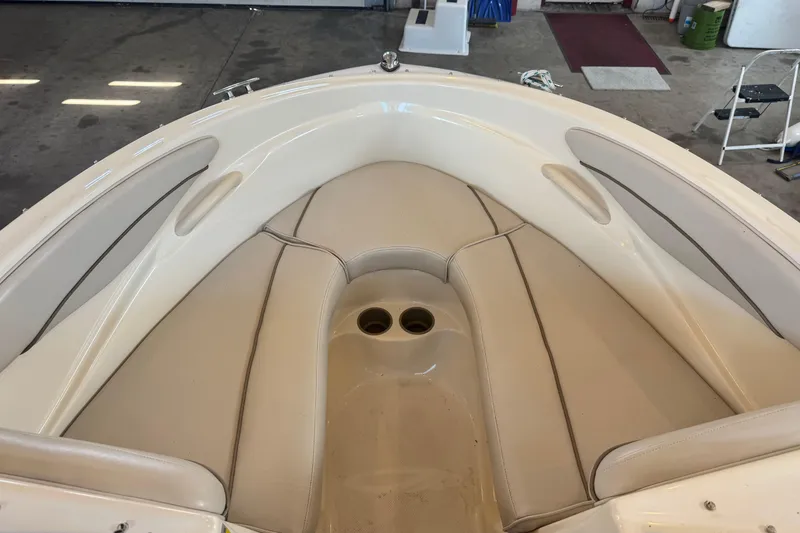 Slide: The Image of 2002 Maxum 1800 SR boat interior with beige seating in a garage setting. - 24