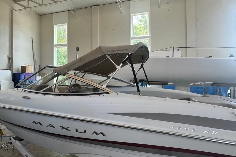 Slide: The Image of 2002 Maxum 1800 SR boat in indoor storage with canopy. - 26