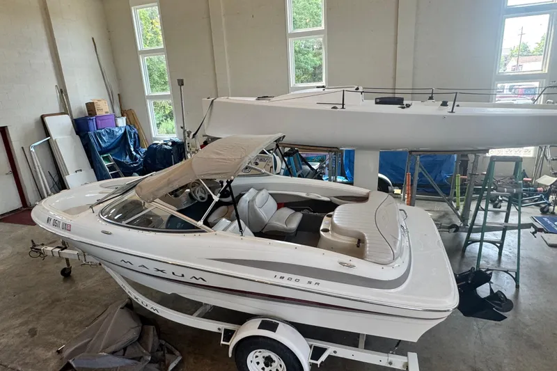 Slide: The Image of 2002 Maxum 1800 SR boat in a garage, white interior, on a trailer. - 28