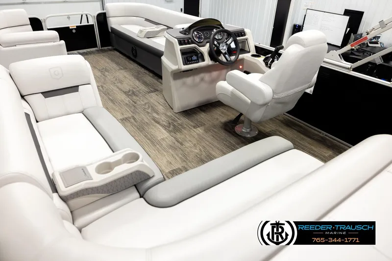 Slide: The Image of 2023 Godfrey SW2286C boat interior with plush seating and modern dashboard. - 11