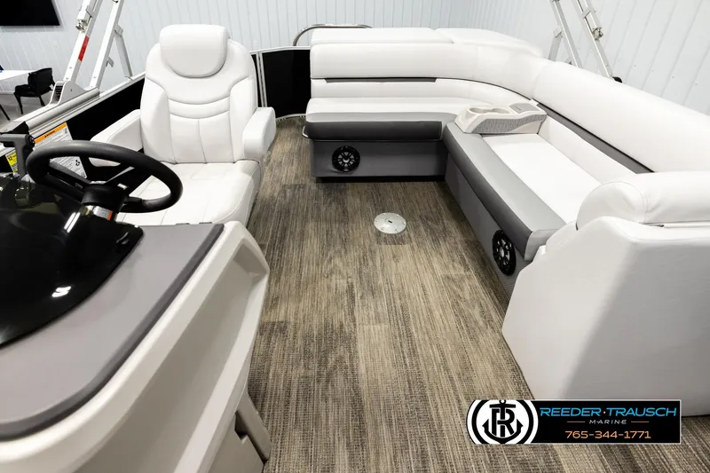 Slide: The Image of 2023 Godfrey SW2286C pontoon boat interior with plush seating and modern helm. - 14