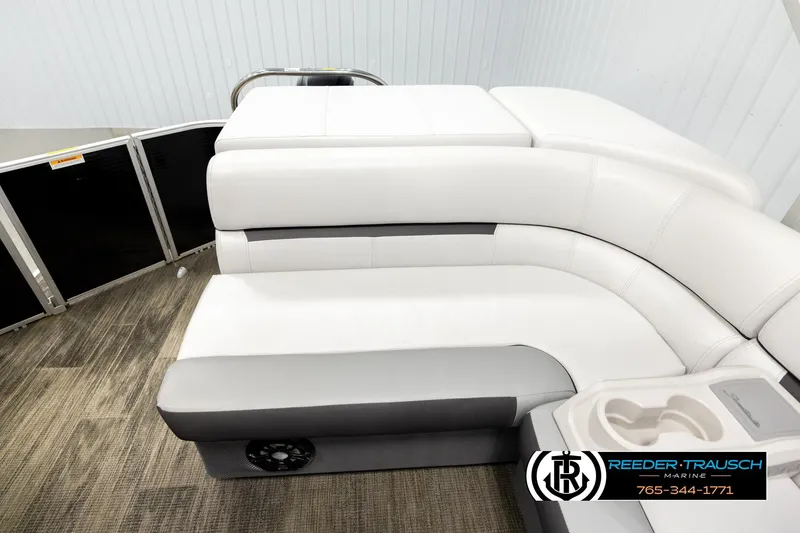 Slide: The Image of 2023 Godfrey SW2286C boat interior with white cushioned seating and cup holders. - 15