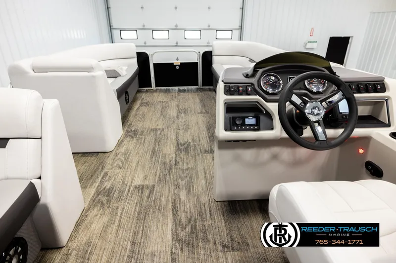 Slide: The Image of Interior of a 2023 Godfrey SW2286C boat with modern dashboard and seating. - 17