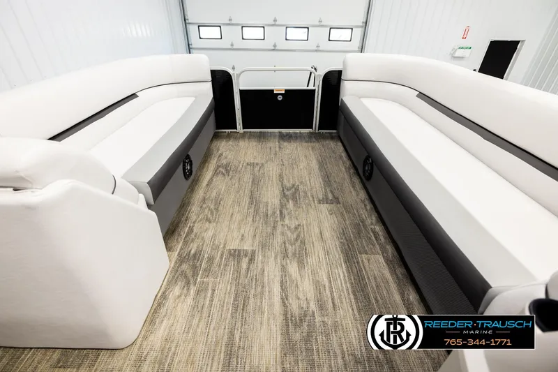 Slide: The Image of Interior of 2023 Godfrey SW2286C pontoon boat with spacious seating and wood-style flooring. - 18