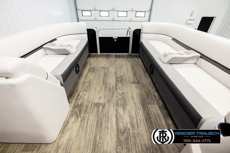 Slide: The Image of Interior of 2023 Godfrey SW2286C pontoon boat with white seating and wood-style flooring. - 19