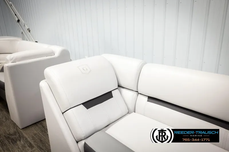 Slide: The Image of 2023 Godfrey SW2286C boat seats in white, displayed indoors at Reeder-Trausch Marine. - 24