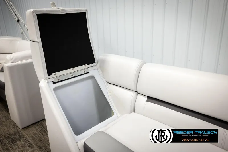 Slide: The Image of Open storage compartment in 2023 Godfrey SW2286C boat seat, white upholstery. - 25