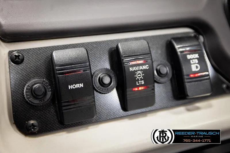 Slide: The Image of Control panel of 2023 Godfrey SW2286C boat with horn, navigation, and dock light switches. - 30