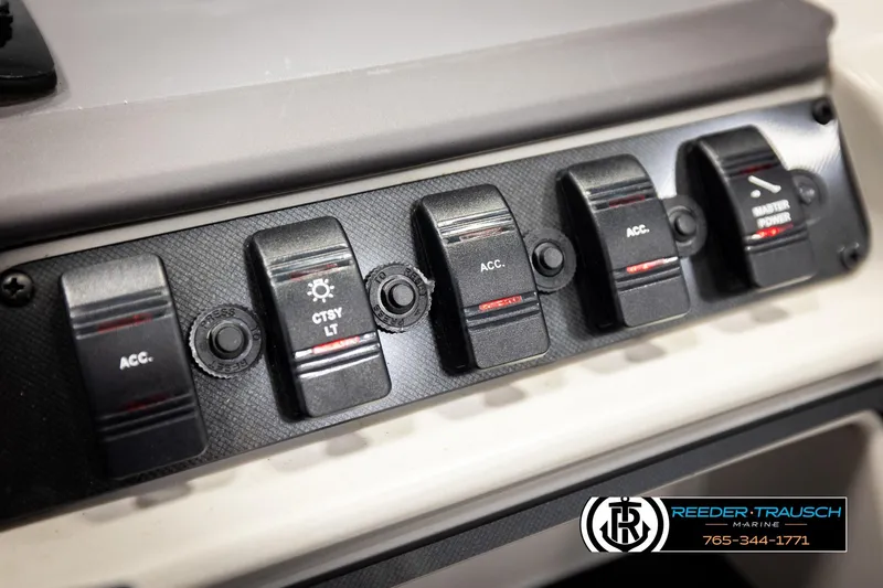 Slide: The Image of Control panel of 2023 Godfrey SW2286C boat with labeled switches and buttons. - 34