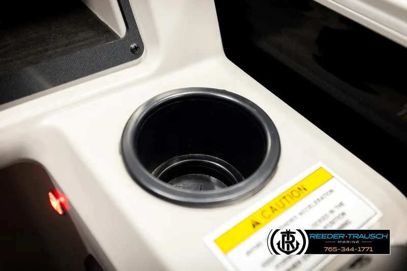 Slide: The Image of Cup holder in 2023 Godfrey SW2286C boat with caution label and Reeder-Trausch Marine logo. - 37