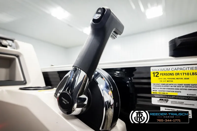 Slide: The Image of Close-up of 2023 Godfrey SW2286C throttle control with capacity label in a boat interior. - 39