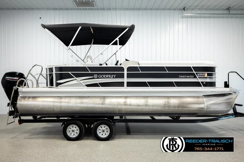 Slide: The Image of 2023 Godfrey SW2286C pontoon boat with black canopy and Mercury engine. - 5