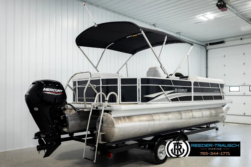 Slide: The Image of 2023 Godfrey SW2286C pontoon boat with Mercury engine in a showroom. - 6