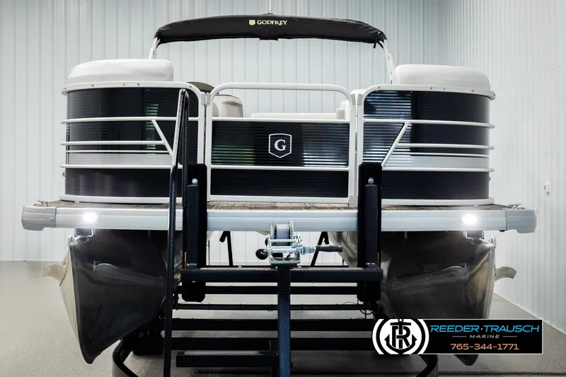 Slide: The Image of 2023 Godfrey SW2286C pontoon boat in showroom, front view with Reeder-Trausch Marine branding. - 8