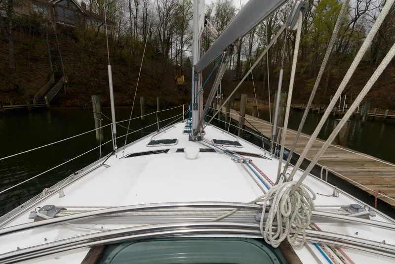 Slide: The Image of 2002 Beneteau 393 sailboat deck view, docked in a wooded marina. - 3