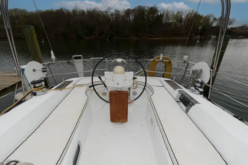 Slide: The Image of Cockpit view of a 2002 Beneteau 393 sailboat on a calm lake. - 5