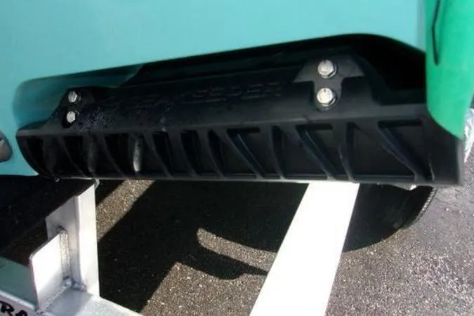 Slide: The Image of 2025 Sportsman Heritage 261 boat hull detail with black trim and bolts. - 1