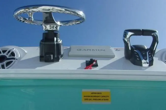 Slide: The Image of 2025 Sportsman Heritage 261 boat dashboard with Garmin system and steering wheel. - 13
