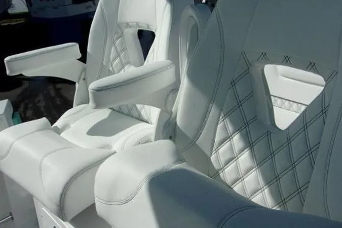 Slide: The Image of Luxurious white seating on 2025 Sportsman Heritage 261 boat with diamond stitching. - 16