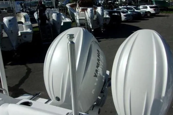 Slide: The Image of 2025 Sportsman Heritage 261 boat with Yamaha engines in a marina setting. - 18