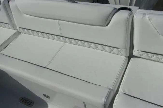 Slide: The Image of White seating on 2025 Sportsman Heritage 261 boat, featuring diamond-patterned upholstery. - 19