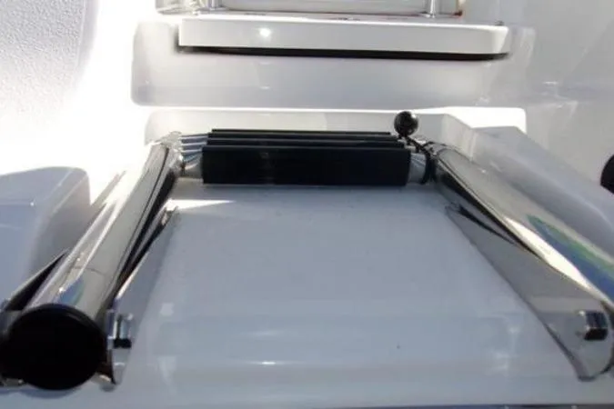Slide: The Image of 2025 Sportsman Heritage 261 boat ladder, stainless steel, folded on deck. - 2