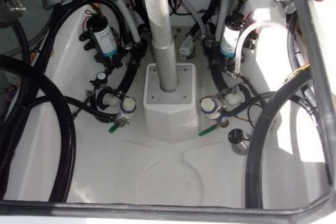 Slide: The Image of Engine compartment of 2025 Sportsman Heritage 261 boat, showcasing hoses and filters. - 20