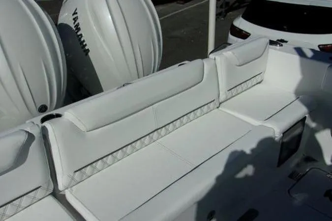 Slide: The Image of 2025 Sportsman Heritage 261 boat with white seating and Yamaha engines. - 4