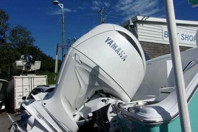 Slide: The Image of 2025 Sportsman Heritage 261 boat with Yamaha outboard motor at a boat shop. - 6